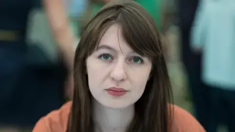 Irish author Sally Rooney states she will not travel to the UK over potential arrest
